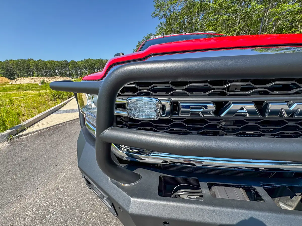 Front grille close-up from low angle with upper guard and grille slats.